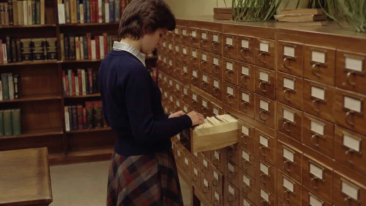 13 Things You Had to Memorize in School That Are Now Obsolete 4 Someone using a vintage library card catalog