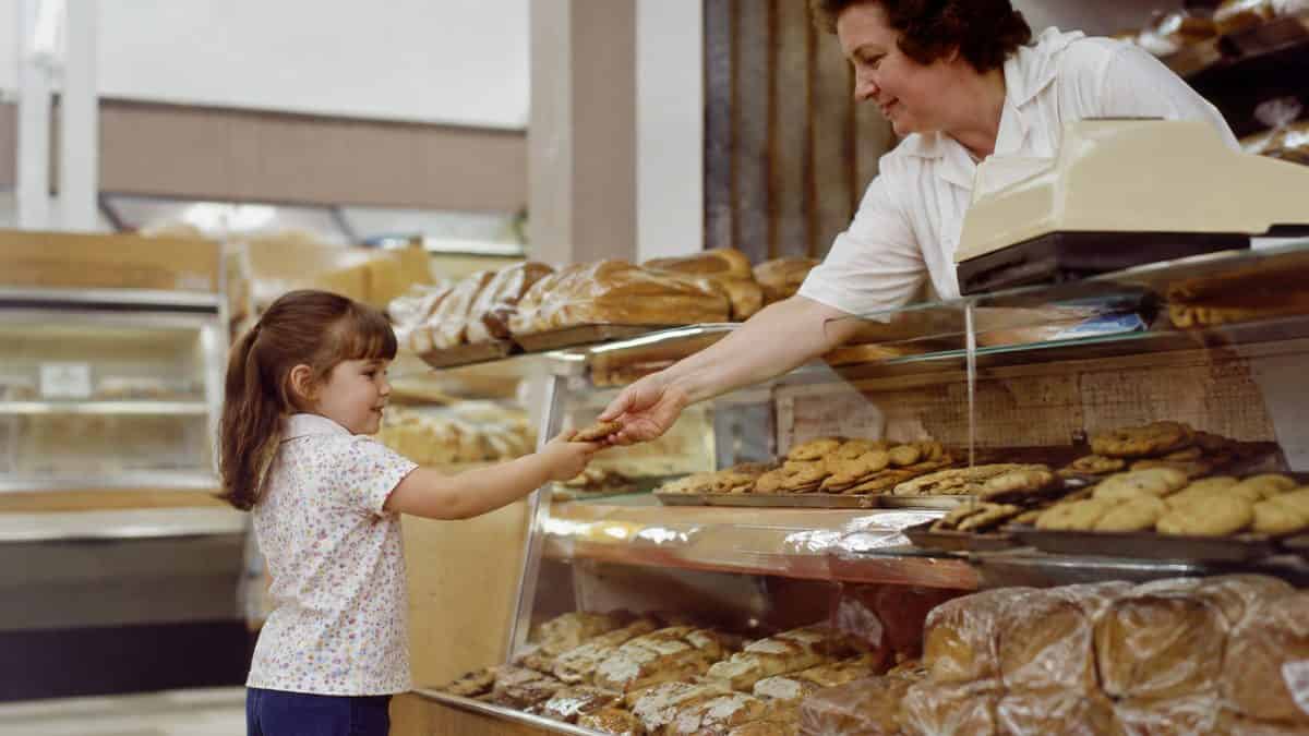 What Kids Used to Do at the Grocery Store That's Unthinkable Now 7 Child receiving cookie at supermarket bakery
