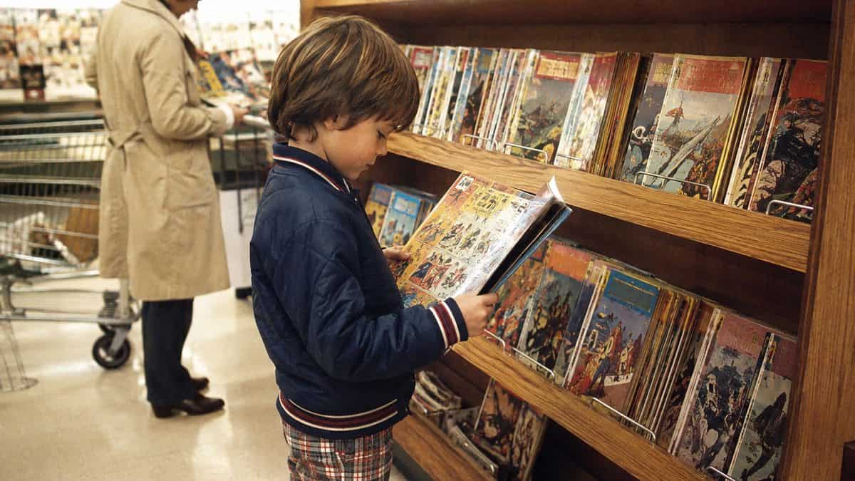 What Kids Used to Do at the Grocery Store That's Unthinkable Now 10 Child reading comics at supermarket rack