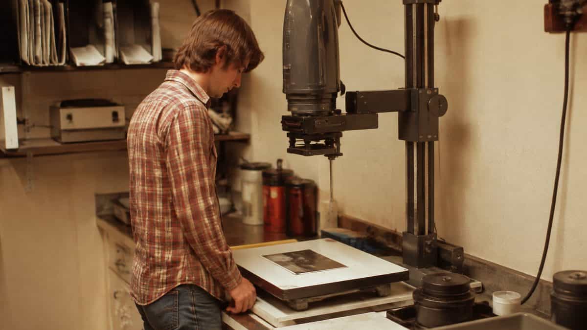 13 Jobs Every High School Kid Could Get That Don't Exist Anymore 13 Person using a darkroom enlarger