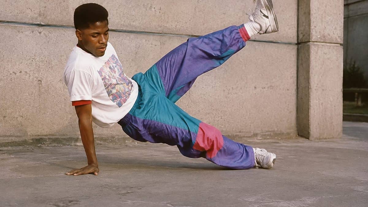 '80s Fashion Trends That Would Break the Internet Today 3 Authentic 1980s photo of a breakdancer wearing colorful parachute pants.
