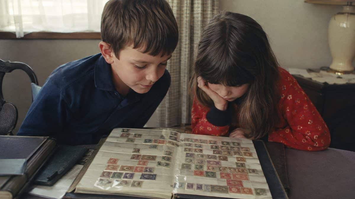 16 Things Everyone Collected That Are Worth Big Money Today 10 Real children looking at a genuine vintage stamp collection