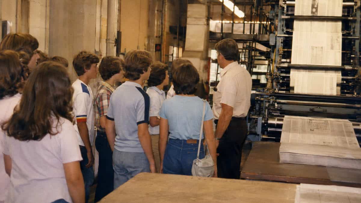 Students touring a newspaper printing facility