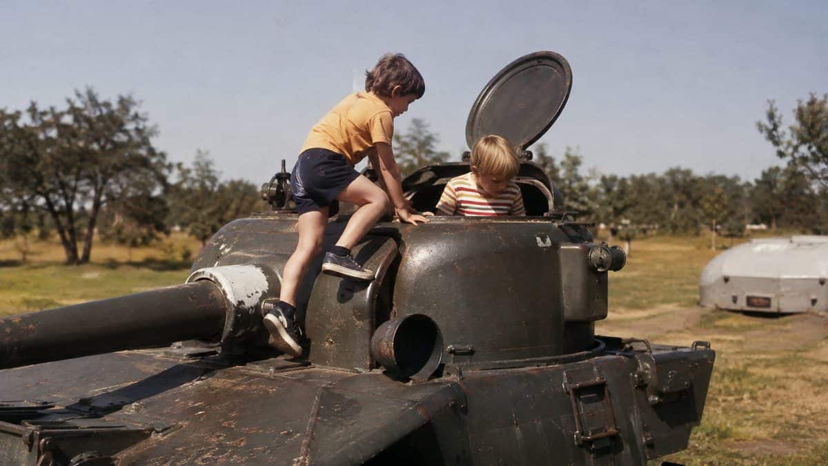 Children playing on decommissioned military equipment