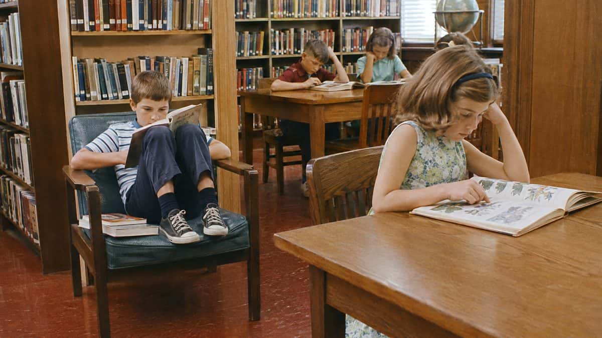 Kids reading in a 1960s public library