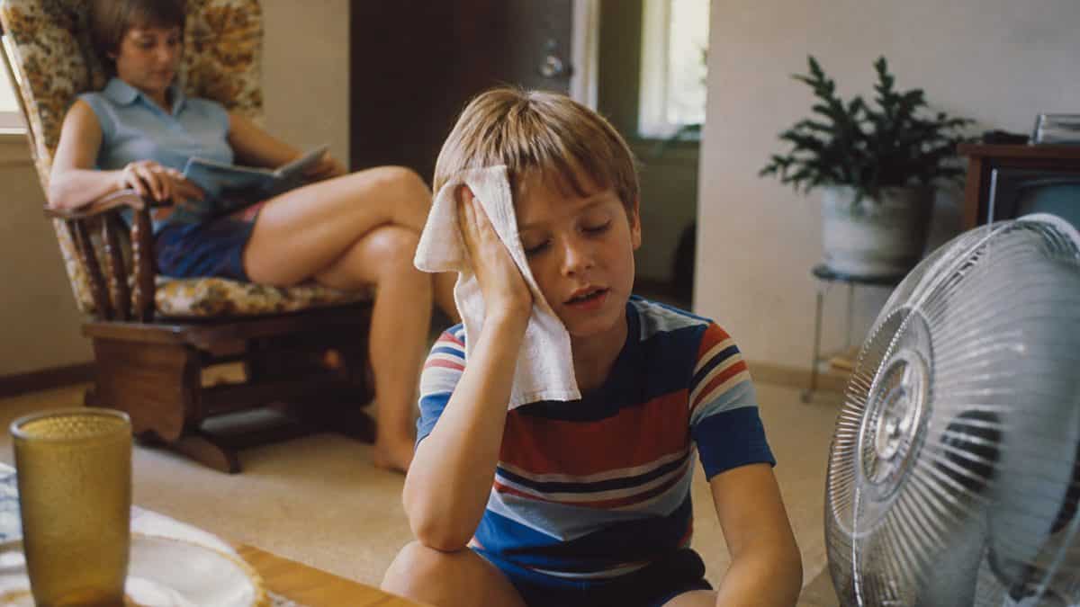 Authentic retro photo of a child cooling off with a wet towel