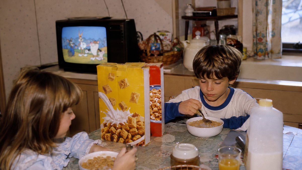 12 Things Every Saturday Morning Cartoon Kid Remembers 2 Children eating breakfast with authentic vintage cereal boxes