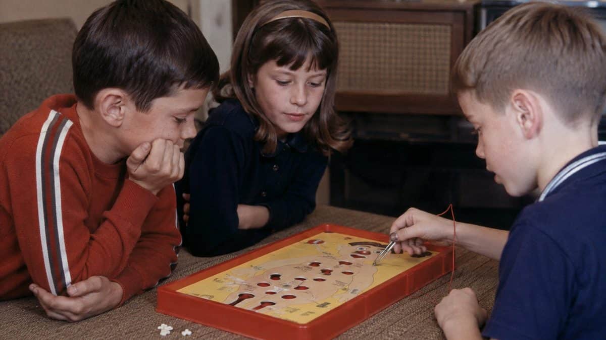 Children playing an authentic vintage Operation board game