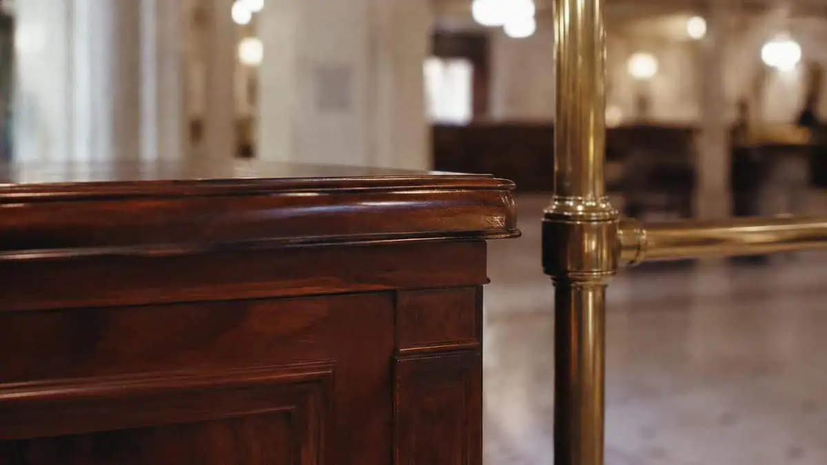 Polished counter and brass rail inside a grand 1960s department store