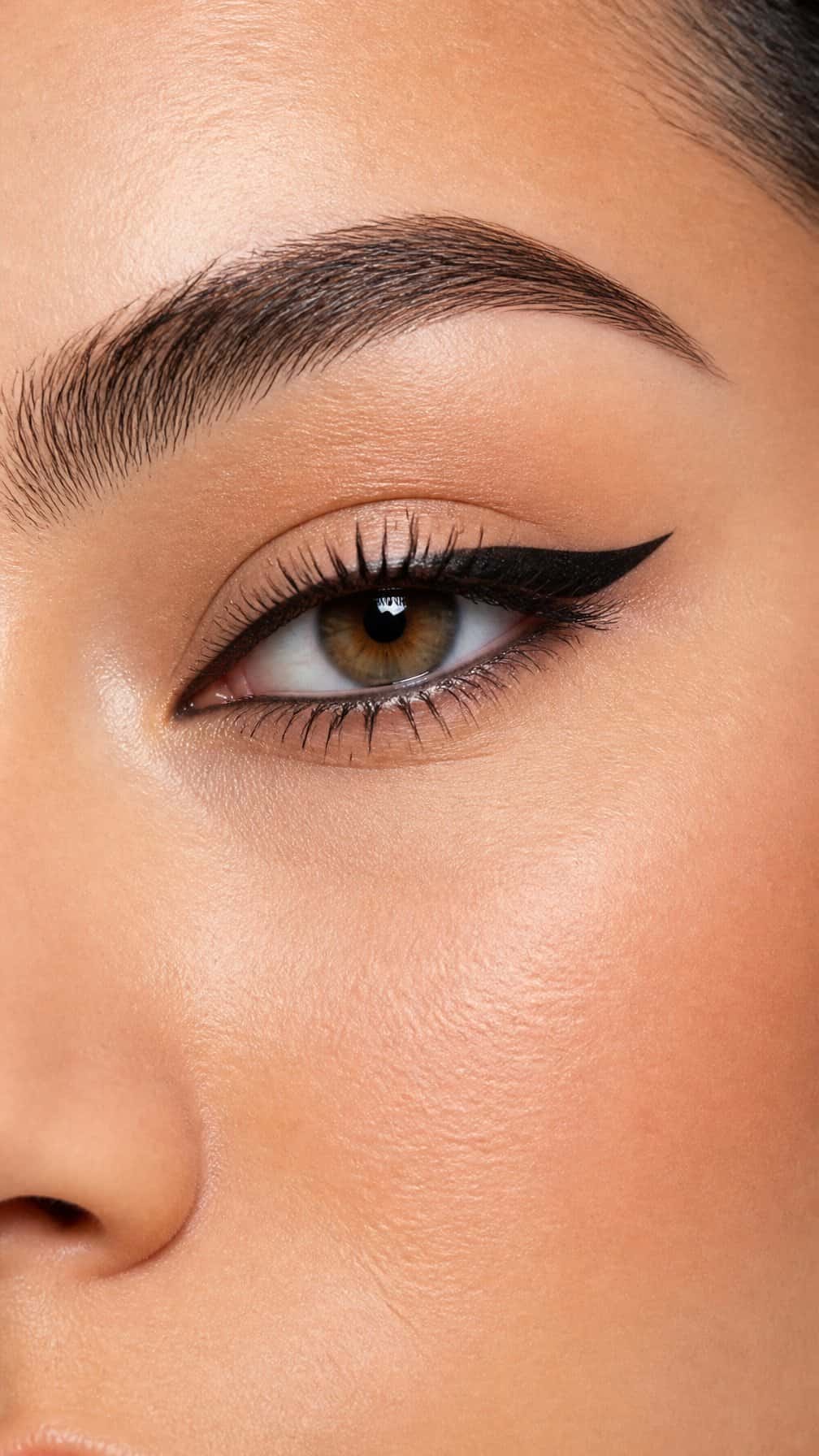 Close-up of an eye wearing winged eyeliner that lifts at the outer corner.