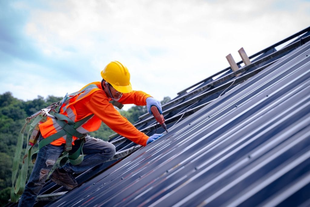 Roofer worker in protective uniform wear and gloves, 