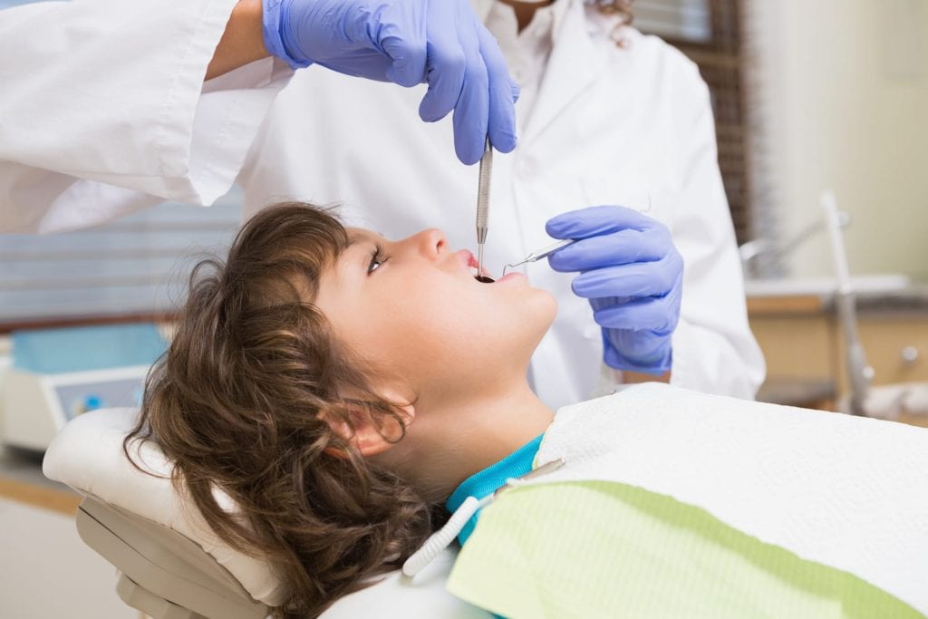 pediatric dentist with a patient