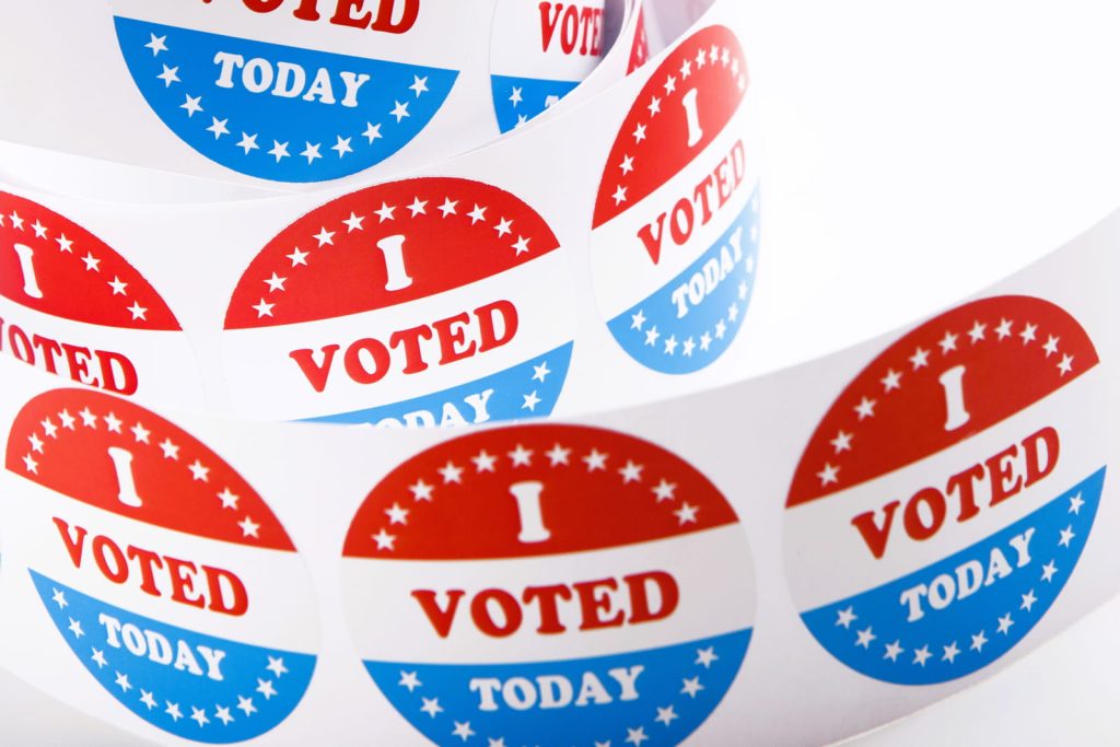 vote-buttons-and-american-flag-background