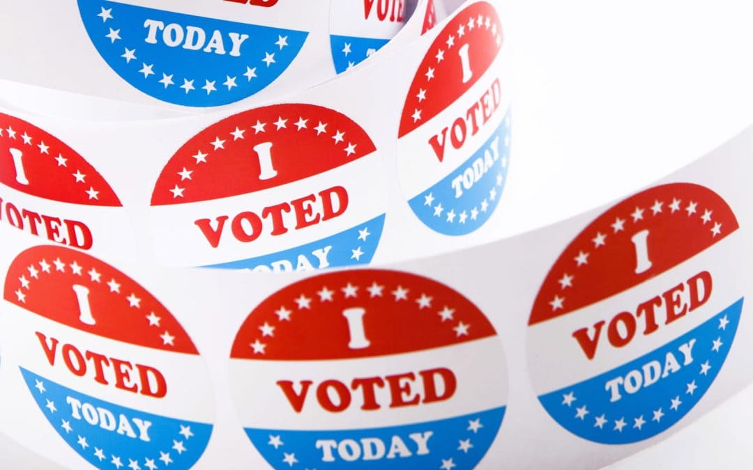 vote-buttons-and-american-flag-background