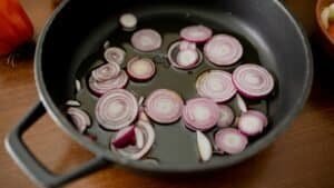 onions being prepared at home in a pan