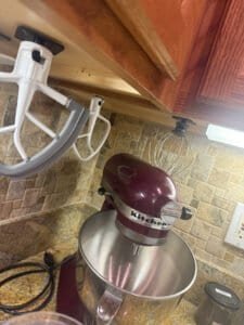 mixer attachments hanging from cabinet organized