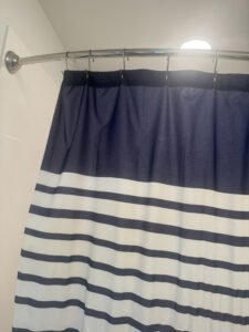 a shower curtain with curved rod thin