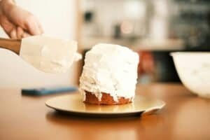 a cake being frosted in home