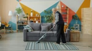 a man vacuuming in a loft