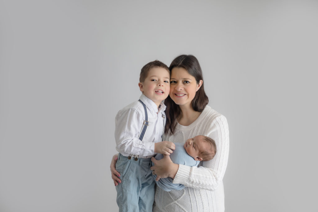 newborn baby boy posed in a professional photo studio in ottawa carp grey loft studio photographer cute family session newborn photographer ottawa
