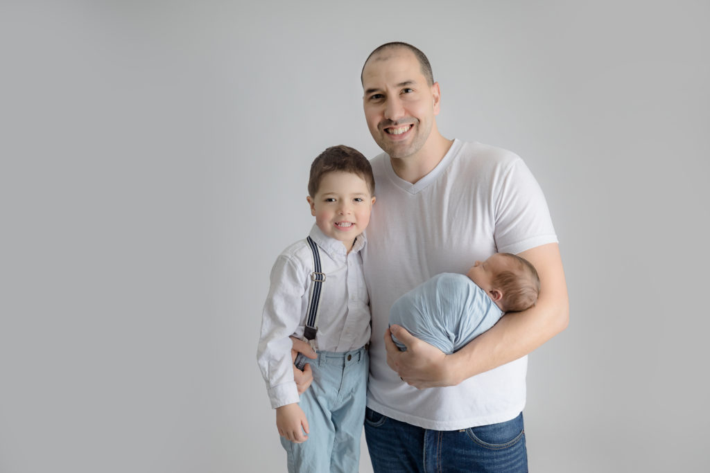 newborn baby boy posed in a professional photo studio in ottawa carp grey loft studio photographer cute family session newborn photographer ottawa