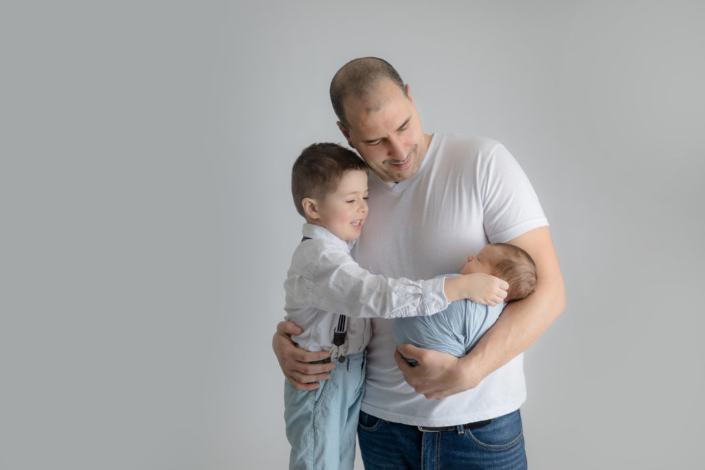 newborn baby boy posed in a professional photo studio in ottawa carp grey loft studio photographer cute family session newborn photographer ottawa