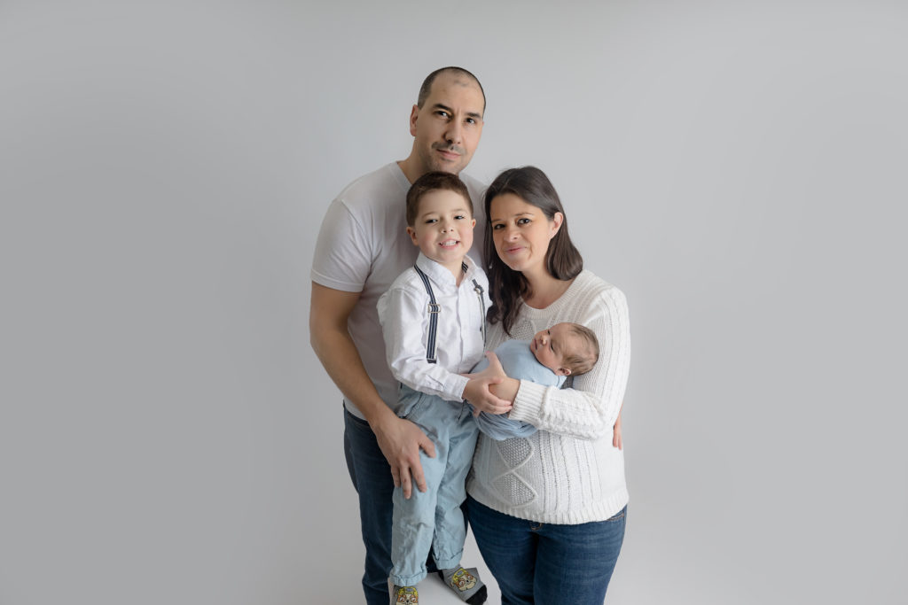 newborn baby boy posed in a professional photo studio in ottawa carp grey loft studio photographer cute family session newborn photographer ottawa