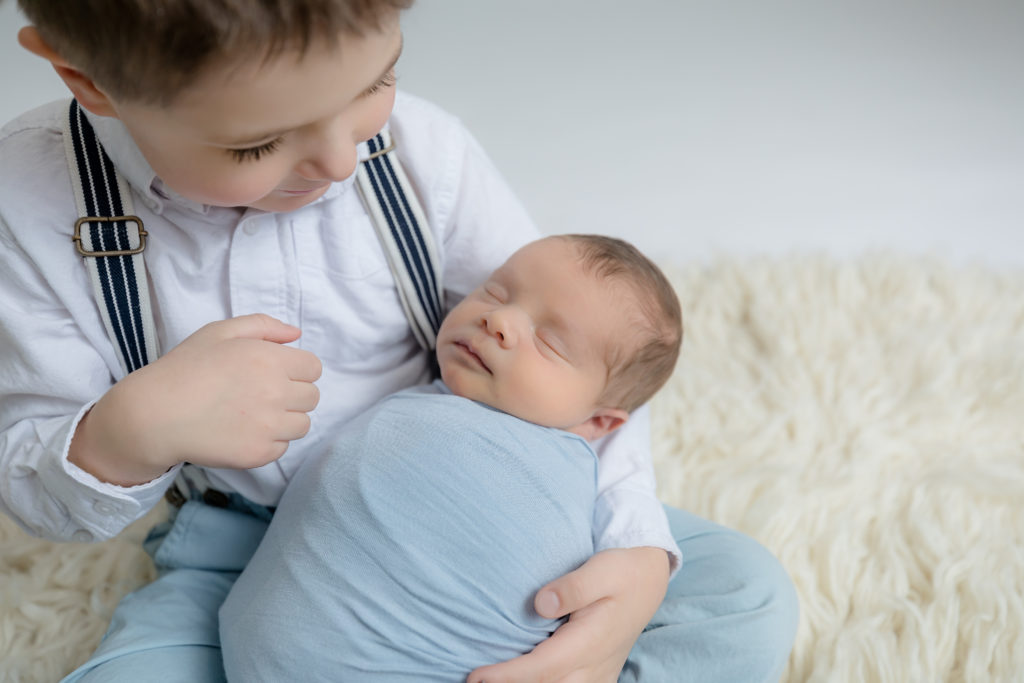 newborn baby boy posed in a professional photo studio in ottawa carp grey loft studio photographer cute family session newborn photographer ottawa