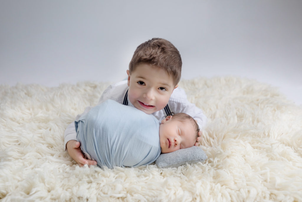 newborn baby boy posed in a professional photo studio in ottawa carp grey loft studio photographer cute family session newborn photographer ottawa