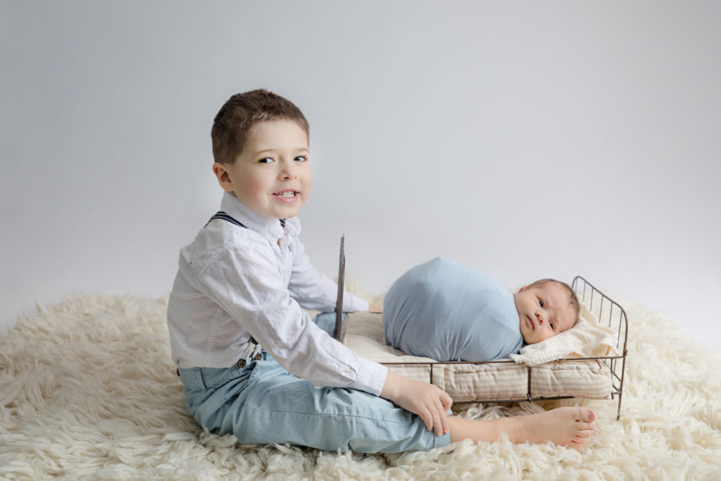 newborn baby boy posed in a professional photo studio in ottawa carp grey loft studio photographer cute family session newborn photographer ottawa