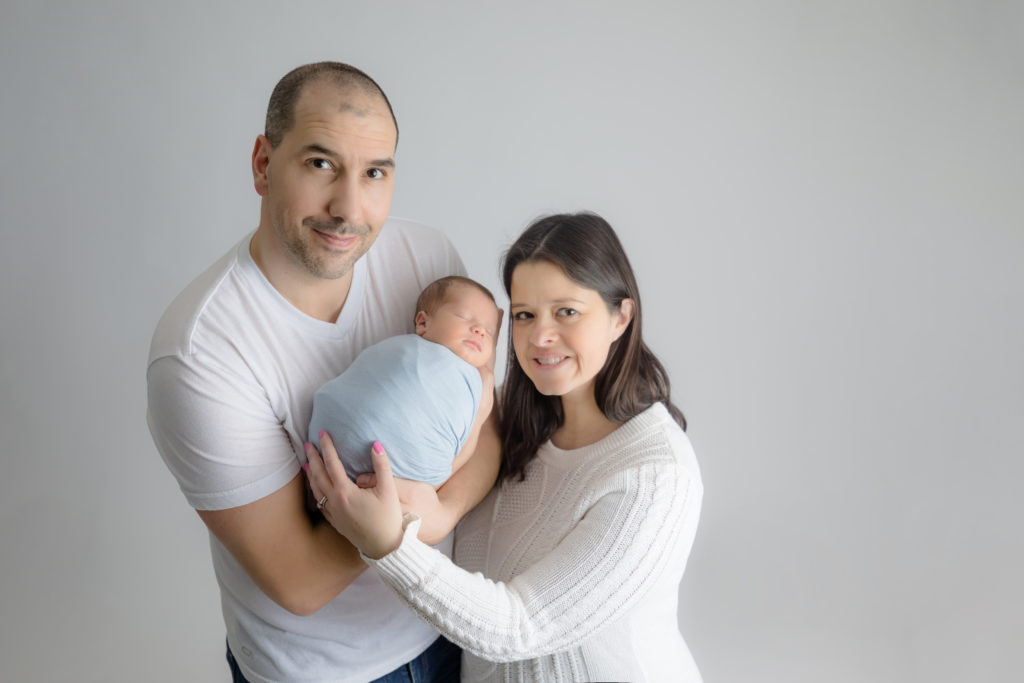 newborn baby boy posed in a professional photo studio in ottawa carp grey loft studio photographer cute family session newborn photographer ottawa