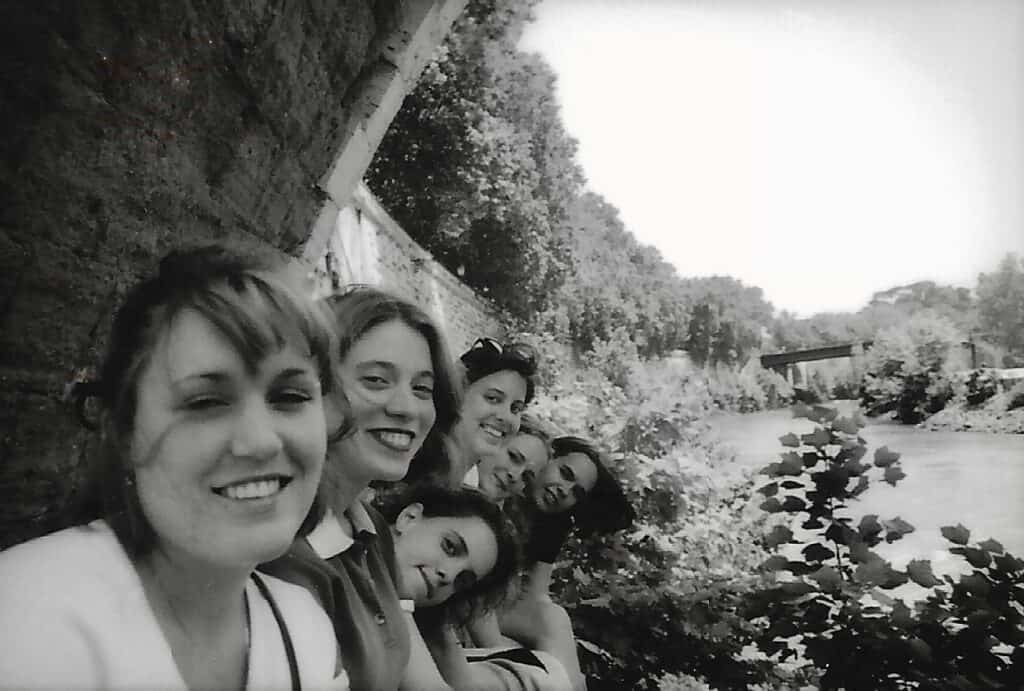 Friends enjoying a day by the river during summer in Italy.
