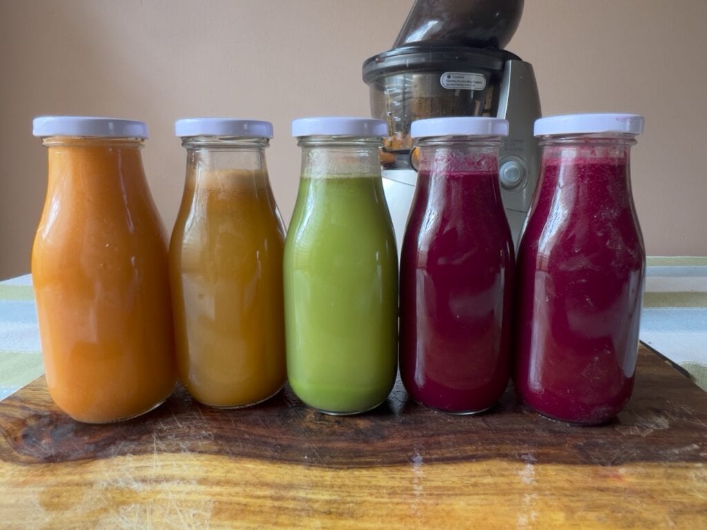 A close-up of vibrant, multicolored juice pulp made from beets, carrots, greens, and other fruits and vegetables after juicing.