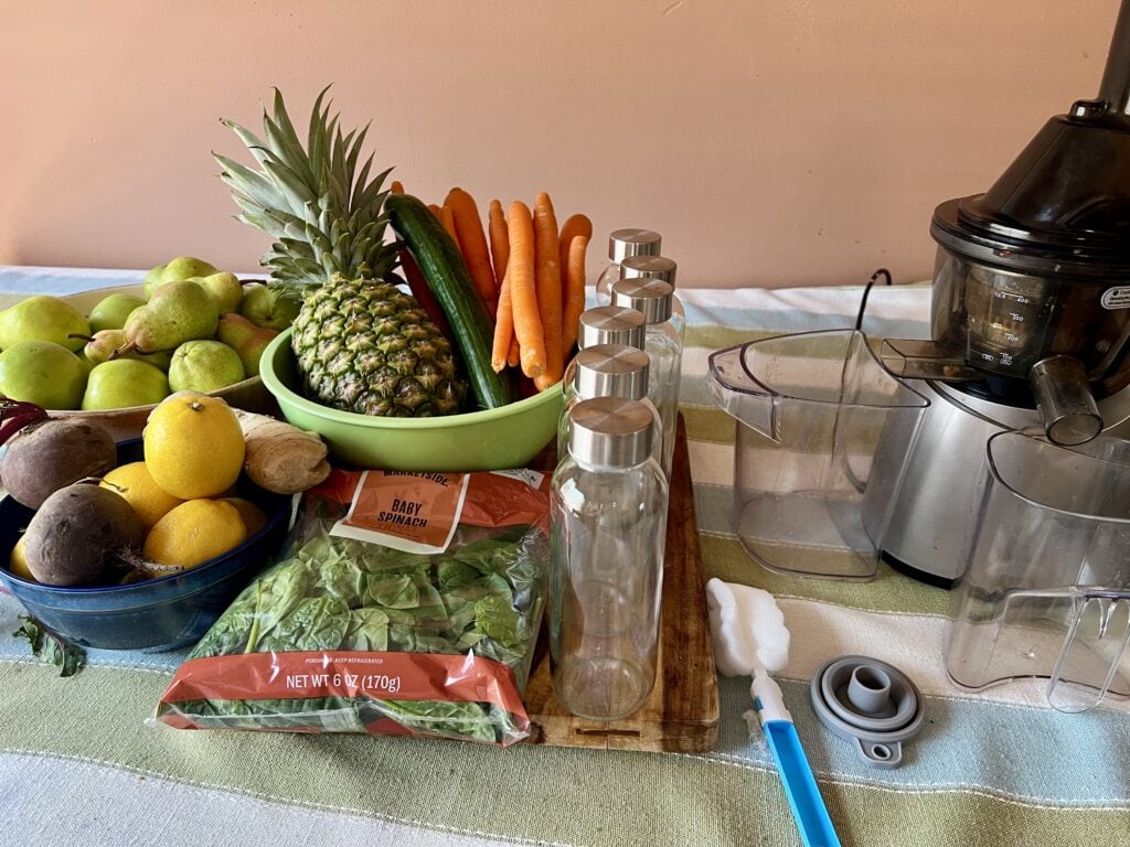 Colorful assortment of fresh fruits and vegetables on kitchen counter.
