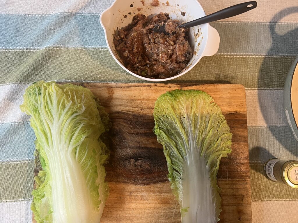 Fresh romaine lettuce leaves on a wooden cutting board for salad.