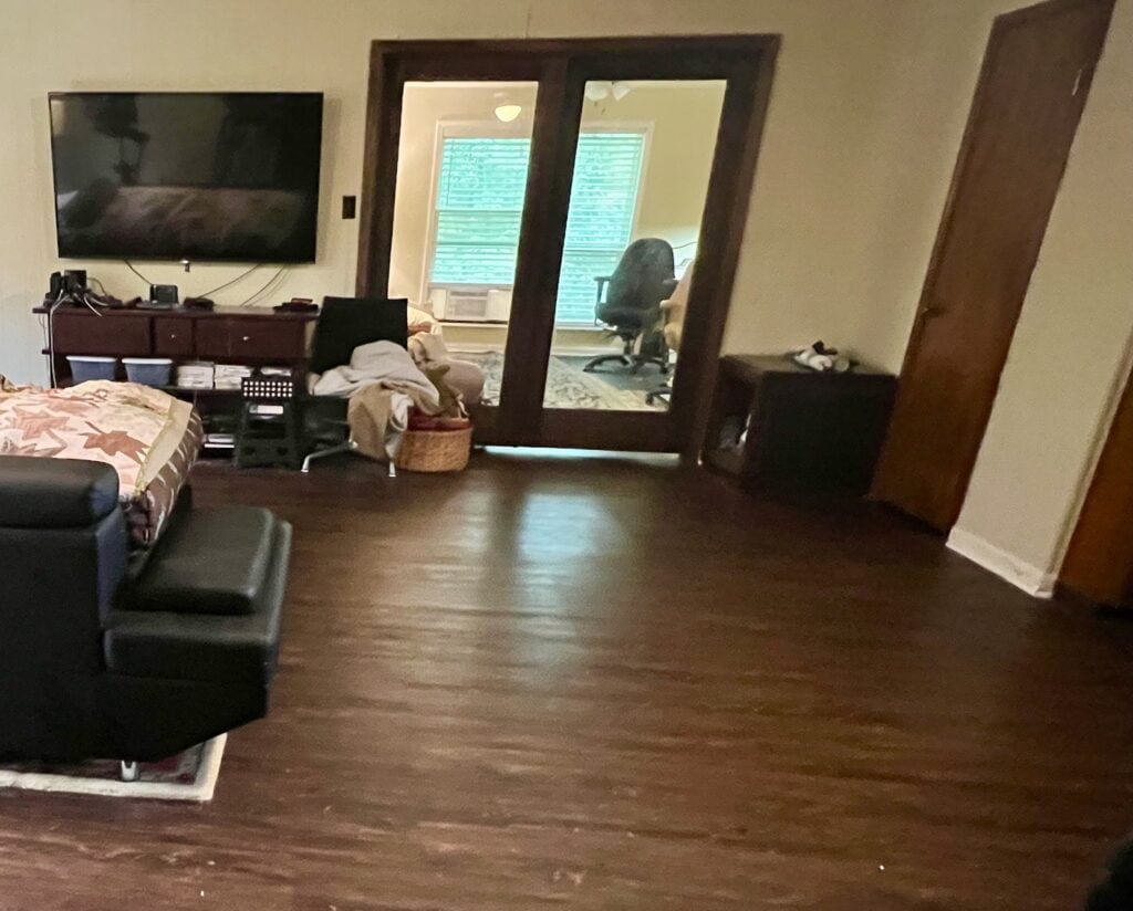 Spacious living room with modern furniture and workout equipment.