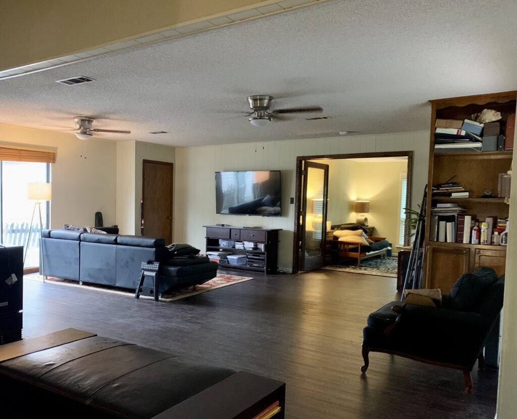 Spacious living room with modern furniture and workout equipment.