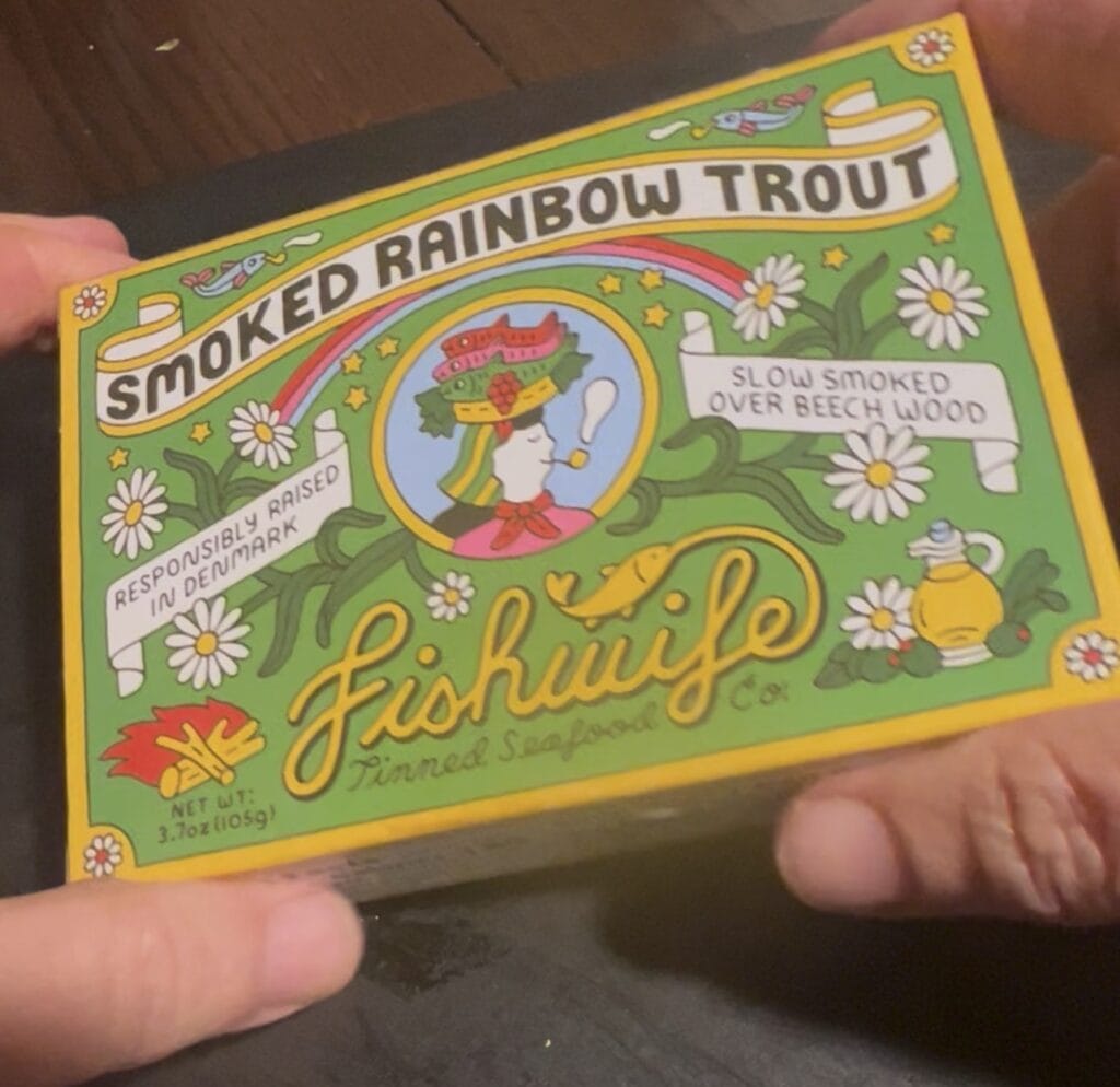 Tinned smoked rainbow trout with colorful packaging and floral design.