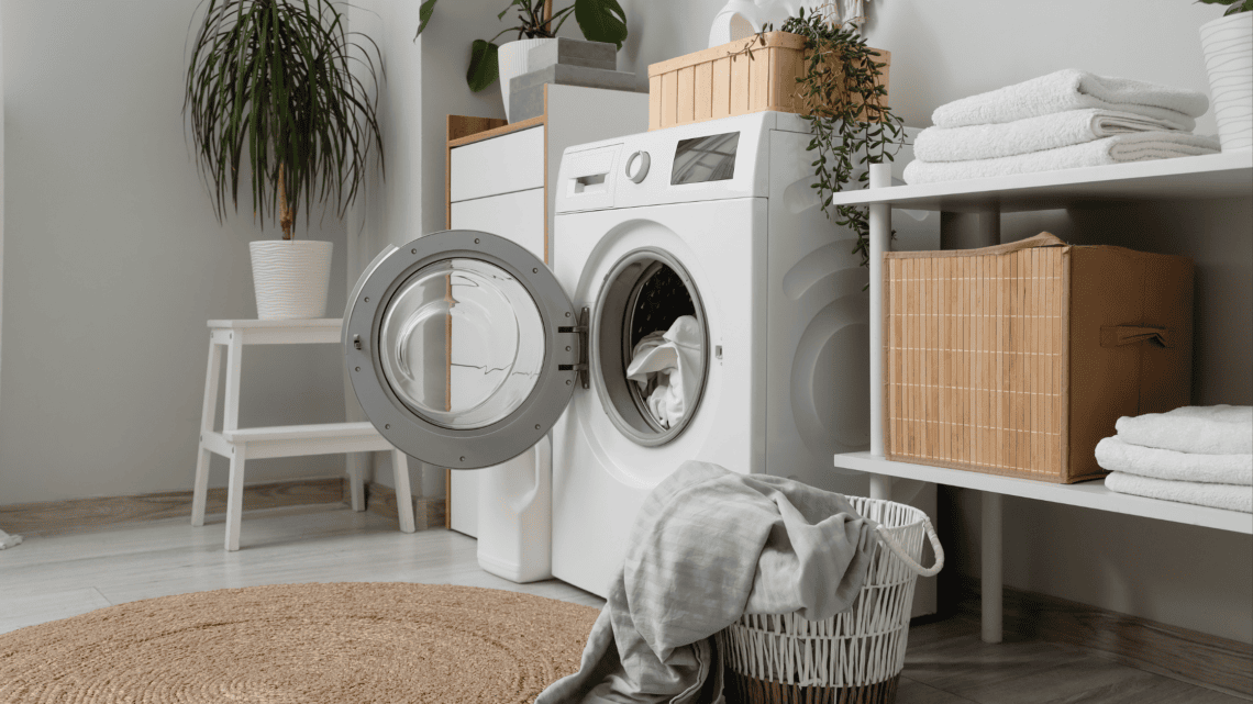Clean laundry room with organized shelves, baskets, and washing machine.