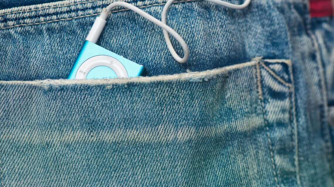 Music player in jeans pocket, close-up shot, casual style.