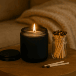 Cozy candle in a black jar with matches on a wooden table, perfect for self-care and gifting.