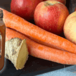 Apples, carrots, and ginger for nutritious slow juicing.