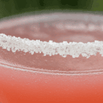 Close-up of a pink cocktail with sugared rim for garnishing drinks.