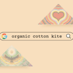 Colorful organic cotton kites with heart and rainbow patterns for eco-friendly flying.