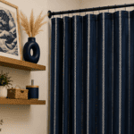 Modern bathroom with navy blue shower curtain and stylish decor.