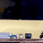 Modern home decor setup with TV and decorative items on wooden shelf.