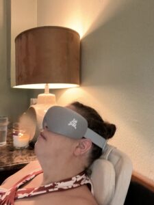 Woman relaxing with a sleep mask in a cozy room at Redcypress Designs.