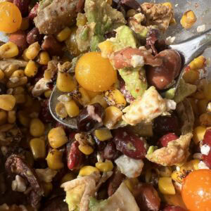 Vibrant chicken and bean salad featuring corn, avocado, and cherry tomatoes, perfect for a flavorful.