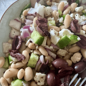 Healthy bean salad with cucumbers, onions, and cheese for a nutritious meal.