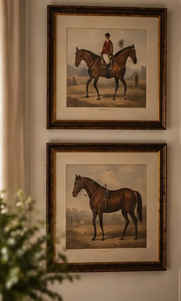 Two framed vintage horse portraits hanging on a wall.